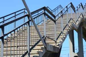 A fragment of a stepped ascent to the pedestrian bridge between the platforms of the railway station photo