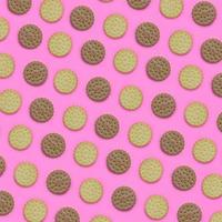 Pattern of a brown biscuits on a pink background. Trendy minimal concept of food and dessert. Abstract flat lay, top view photo