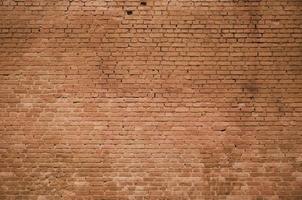 The texture of the brick wall of many rows of bricks painted in brown color photo