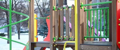 Fragment of a playground made of plastic and wood, painted in different colors photo