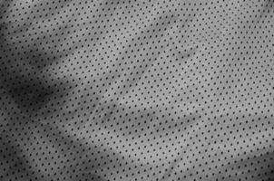 Fondo de textura de tela de ropa deportiva. vista superior de la superficie textil de tela de nailon de poliéster gris. oscuro foto