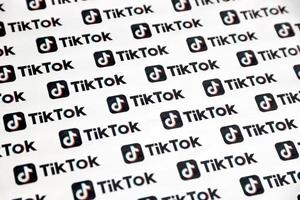 TERNOPIL, UKRAINE - MAY 2, 2022 Many TikTok logo printed on paper. Tiktok or Douyin is a famous Chinese short-form video hosting service owned by ByteDance