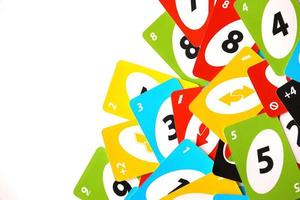 TERNOPIL, UKRAINE - MAY 15, 2022 Many colorful UNO game cards on white background. UNO is an American shedding-type card game that is played with a specially printed deck photo