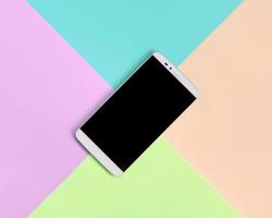 Modern smartphone with black screen on texture background of fashion pastel pink, blue, coral and lime colors photo