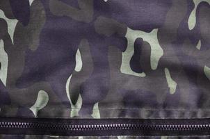 Texture of fabric with a camouflage painted in colors of the marsh. Army background image photo
