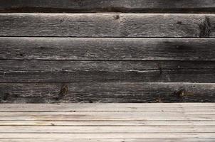 Free space above the wooden surface against the background of a dark wooden wall photo