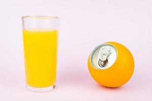 Orange juice on pink background photo