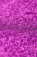 Pink decorative sequins. Background image with shiny bokeh lights from small elements photo