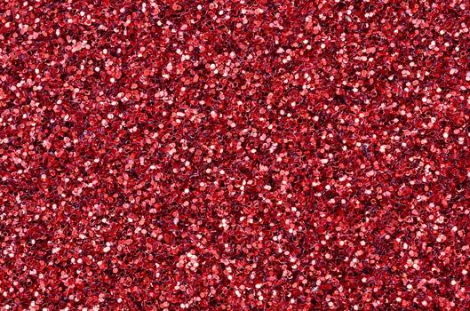 A huge amount of red decorative sequins. Background texture with shiny, small elements that reflect light in a random order. Glitter texture photo