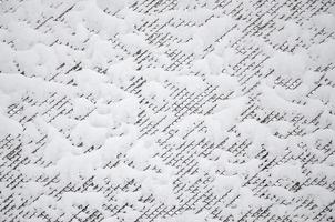 Close-up metal mesh covered with a thick layer of snow in the cells photo