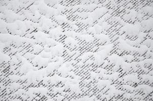 Close-up metal mesh covered with a thick layer of snow in the cells photo