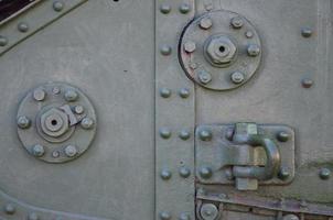 The texture of the wall of the tank, made of metal and reinforced with a multitude of bolts and rivets. Images of the covering of a combat vehicle from the Second World War photo