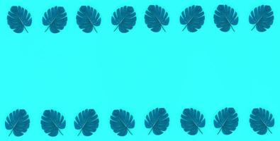 Tropical palm monstera leaves lies on a pastel colored paper. Nature summer concept pattern. Flat lay composition. Top view photo