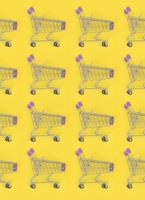 Shopping addiction, shopping lover or shopaholic concept. Many small empty shopping carts perform a pattern on a pastel colored paper background. Flat lay composition, top view photo