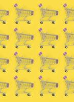 Shopping addiction, shopping lover or shopaholic concept. Many small empty shopping carts perform a pattern on a pastel colored paper background. Flat lay composition, top view photo