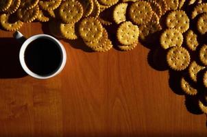 Small coffee cup and salted cracker photo