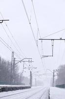 Railway station in the winter snowstorm photo