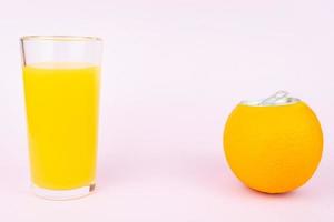 Orange juice on pink background photo