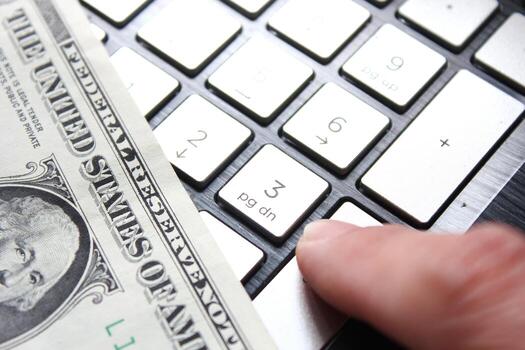 dollar bill with laptop computer and mouse photo