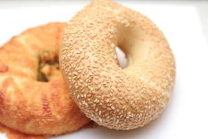 bagel, 2 donut shaped breads stacked on white background photo