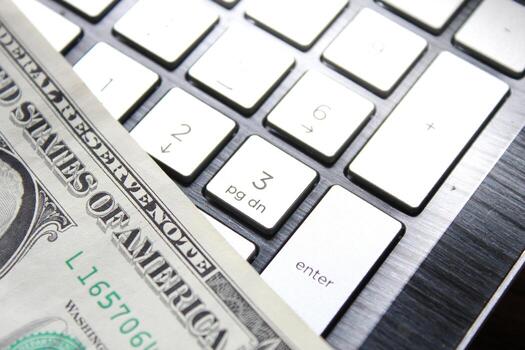 dollar bill with laptop computer and mouse photo