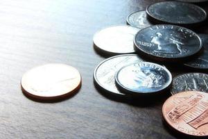 Dollar coins scattered on a wooden table, photo