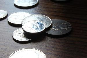 Dollar coins scattered on a wooden table, photo