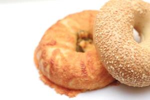 bagel, 2 donut shaped breads stacked on white background photo