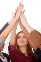 Unity of people. Group of cheerful young people standing close to each other and holding hands photo