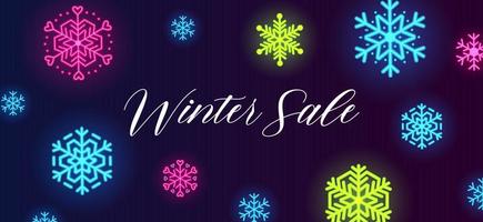 banner de venta de invierno con copos de nieve de colores neón sobre fondo azul oscuro. vector