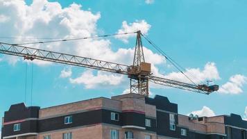 Timelapse footage of a high crane works on building site with a house video