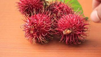 The rambutan placed on the table is brown video