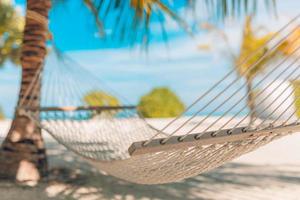 playa idílica con cocoteros y hamacas, vibraciones tranquilas y relajantes de verano. primer plano recreativo, paisaje de playa pacífica. . perfecta escena de playa vacaciones y concepto de vacaciones de verano foto