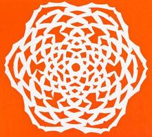 white snowflake on orange paper photo