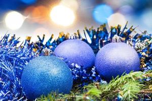 Christmas blue baubles on blurred blue background photo