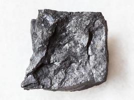 raw carbonaceous shale stone on white photo