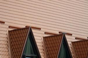 The house is equipped with high-quality roofing of metal tiles. A good example of perfect modern roofing. The building is reliably protected from adverse weather conditions photo