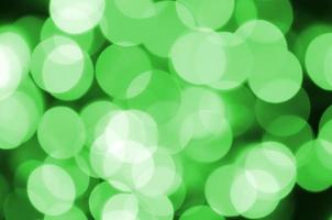 Green abstract Christmas blurred luminous background. Defocused artistic bokeh lights image photo