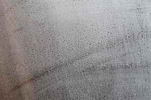 Window glass with condensate or steam after heavy rain, Texture or background image photo