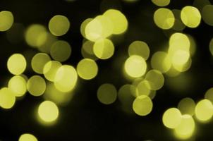 Bokeh effect golden yellow defocused light background. Christmas Lights Concept photo