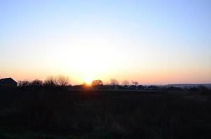 Dawn in the village. Sunrise in the suburban landscape photo