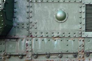 Abstract green industrial metal textured background with rivets and bolts photo