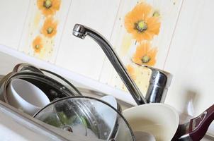 Dirty dishes and unwashed kitchen appliances filled the kitchen sink photo