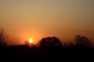 Dawn in the village. Sunrise in the suburban landscape photo