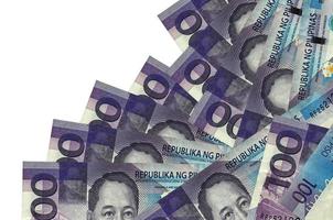 100 Philippine piso bills lies in different order isolated on white. Local banking or money making concept photo