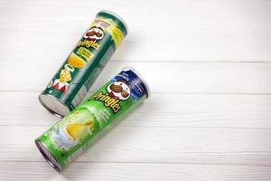 KHARKOV. UKRAINE - MAY 2, 2019 Pringles sour cream onion and cheese onion flavour. Cardboard tube cans with Pringles chips. Pringles is a brand of potato snack chips owned by Kellogg Company photo