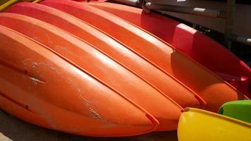 Bright orange kayaks and canoes stored outside video