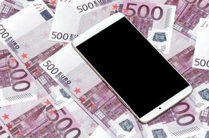 Purple 500 euro money bills and a smartphone with black screen. Copy space. The concept of online banking, money management and shopping with modern technology photo