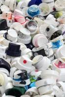 A pattern of many used and soiled nozzles from spray cans with aerosol paint. Background texture of the street art of drawing graffiti on the walls photo
