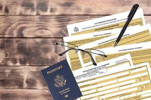 Department of State form DS11 Application for a U.S. Passport lies on table and ready to fill. Paperwork during operations with US Passport concept photo